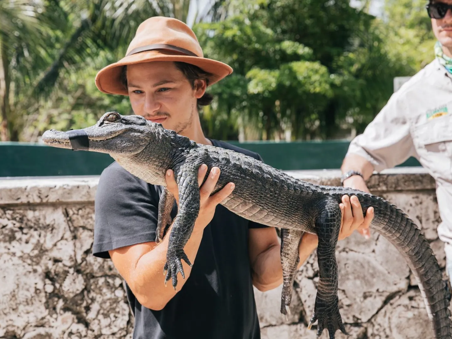 person holding a juvenile alligator at everglades alligator farm