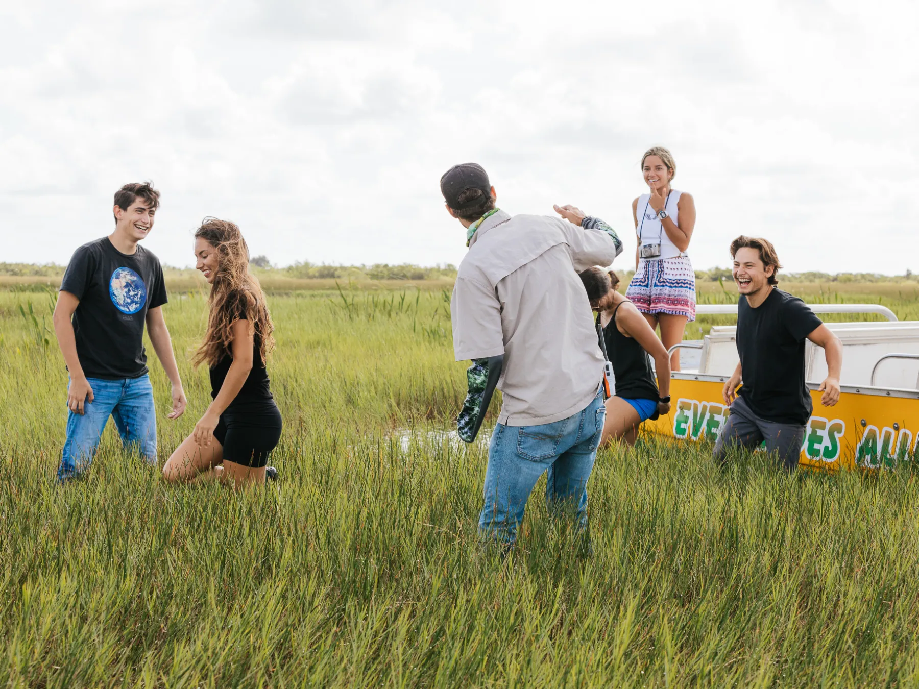 a group of people standing in the everglades