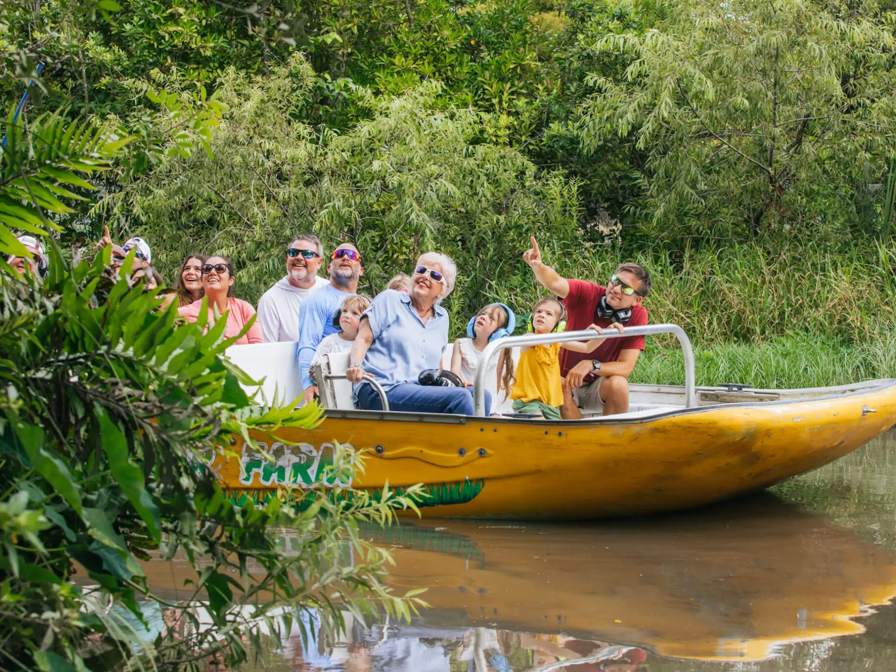 a group of people riding on the back of a boat
