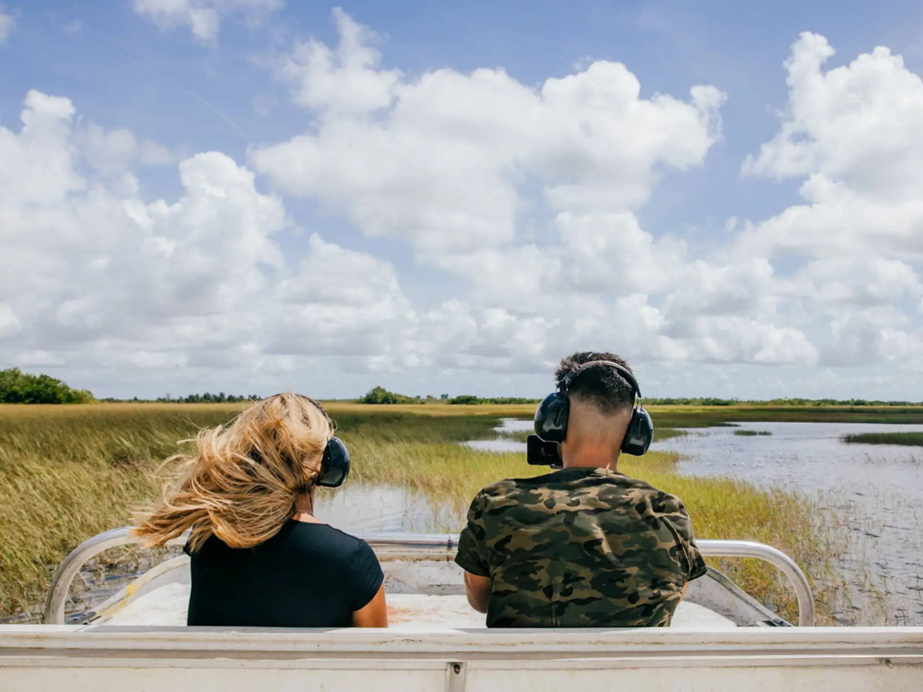 a person sitting on a bench next to a body of water