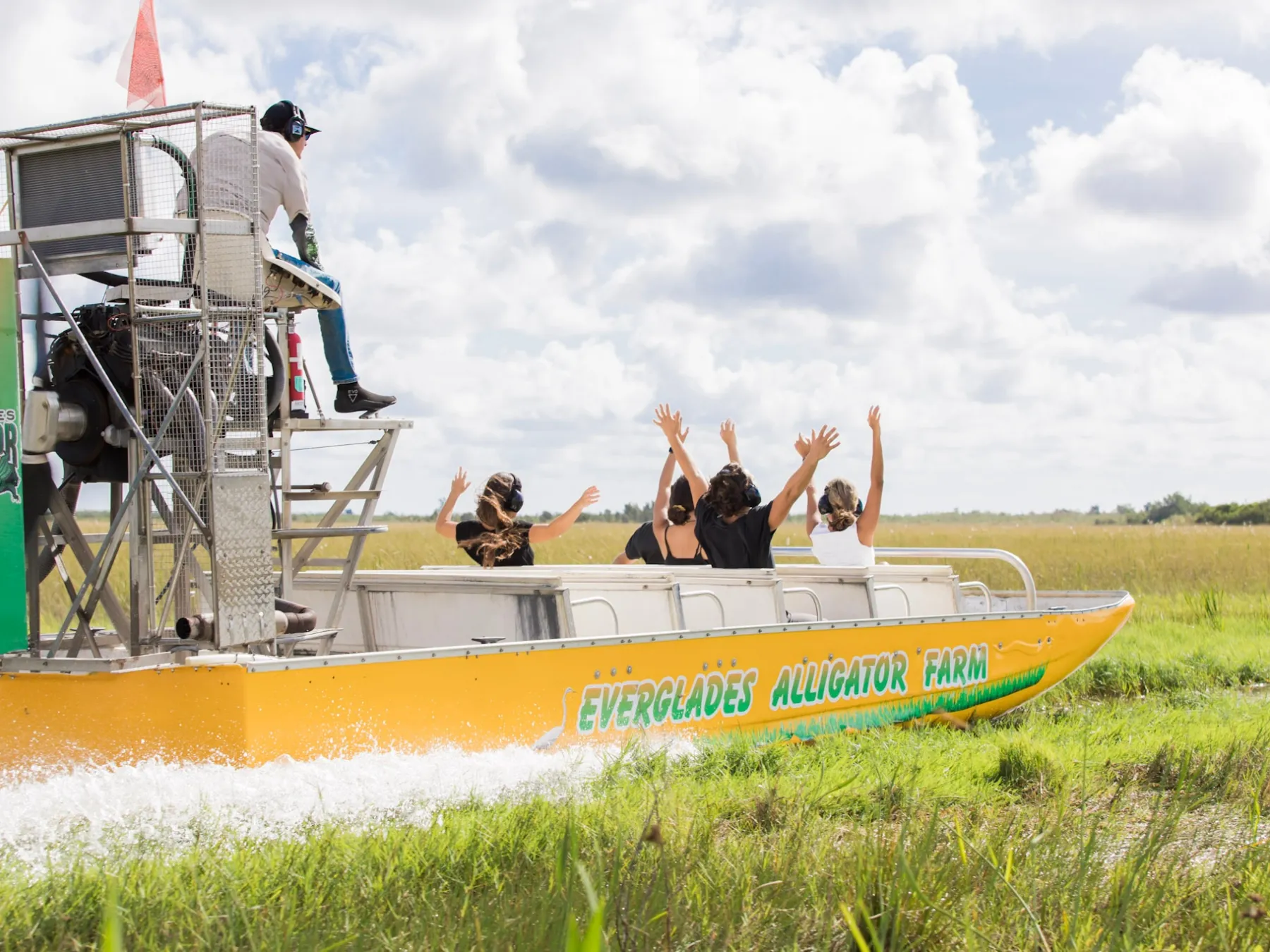 a group of people in a boat on the grass