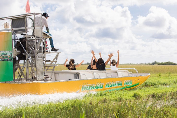 a group of people in a boat on the grass