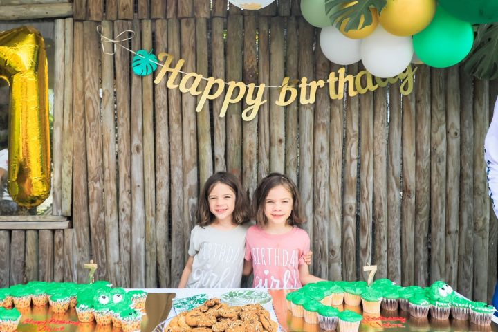 a person standing in front of a birthday cake