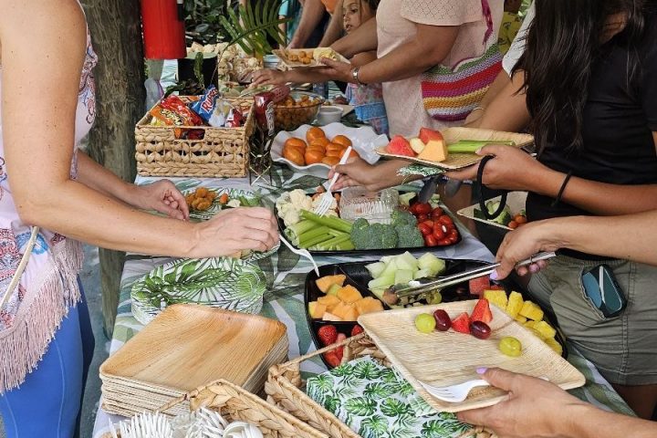 a group of people standing around a table